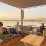 This is what travel looks like without crowds – boutique experience on the Nile Boutique travel in Egypt: Three travelers enjoy an uncrowded Nile River experience aboard a traditional dahabiya sailboat