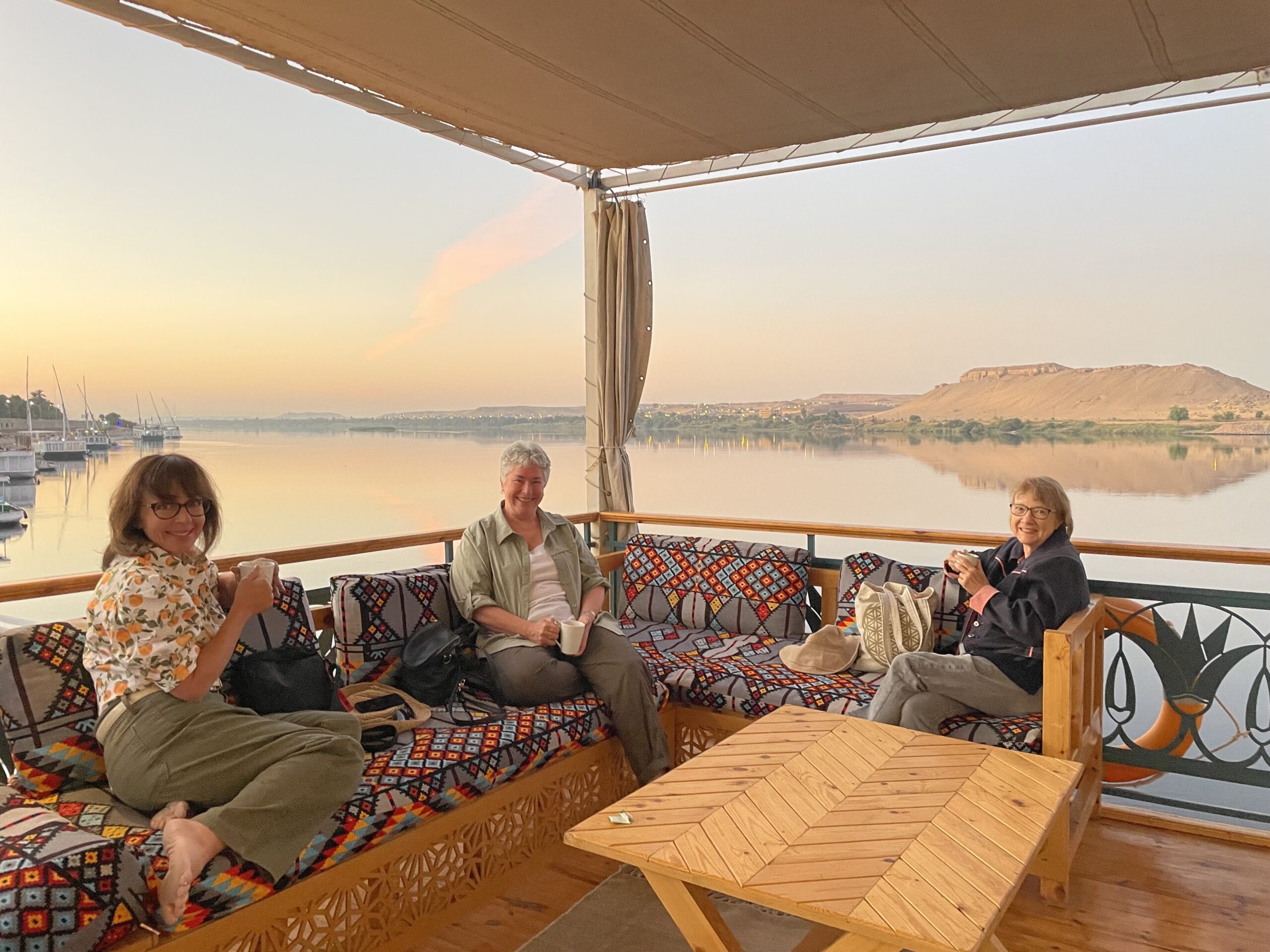 Boutique travel in Egypt: Three travelers enjoy an uncrowded Nile River experience aboard a traditional dahabiya sailboat