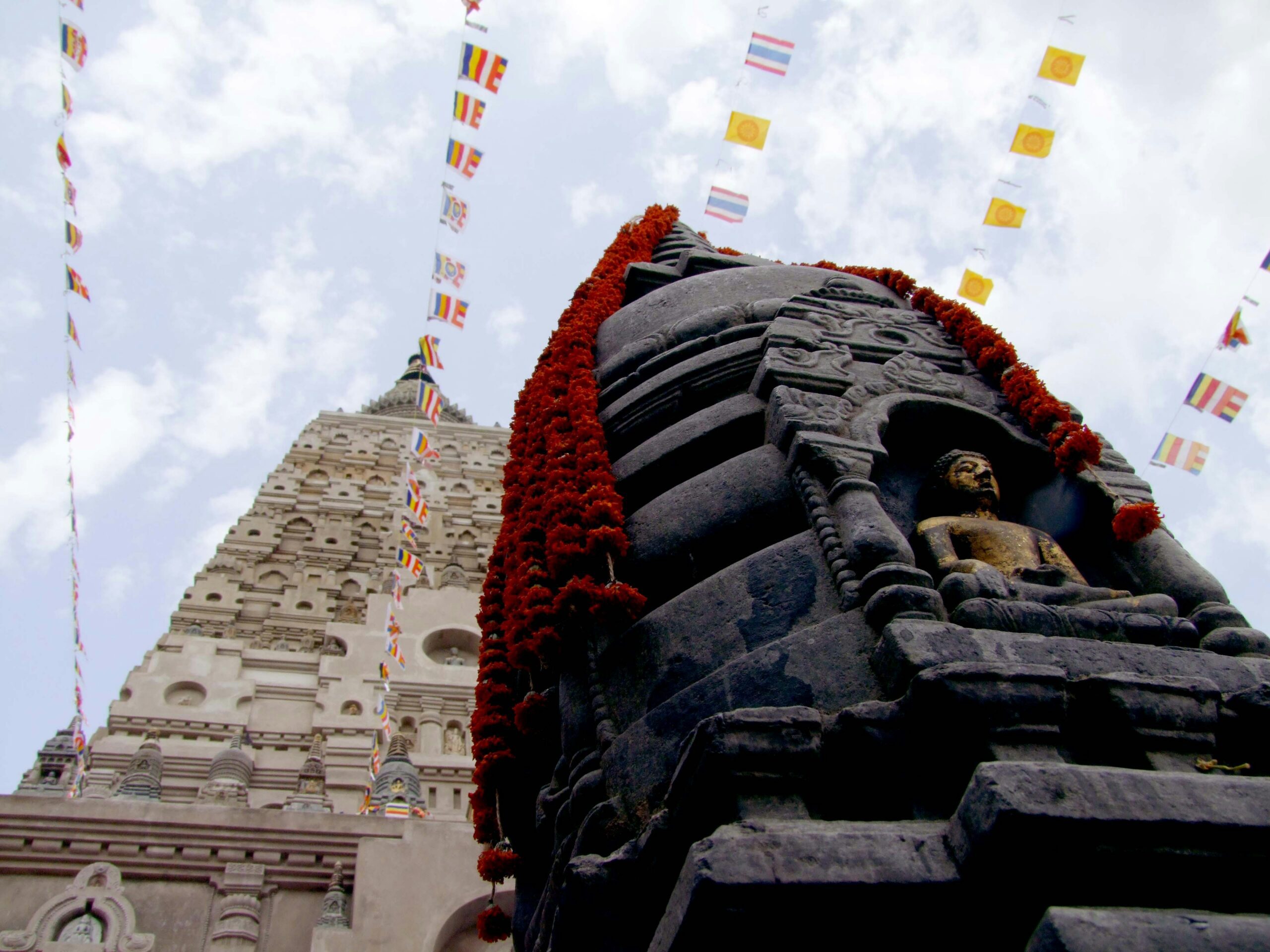 The Mahabodhi Temple at Bodh Gaya, Bihar, prayer flags and marigold garlands against the spire